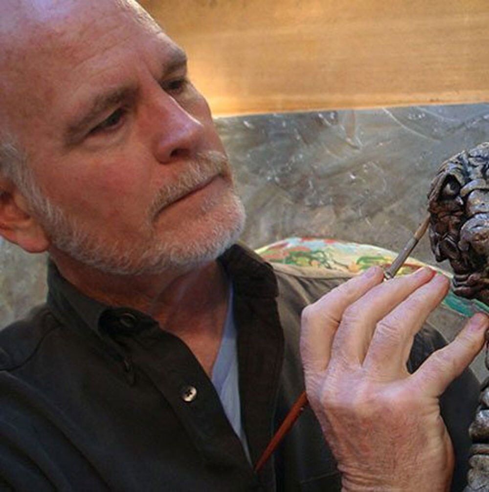 Man Painting His Sculpture
